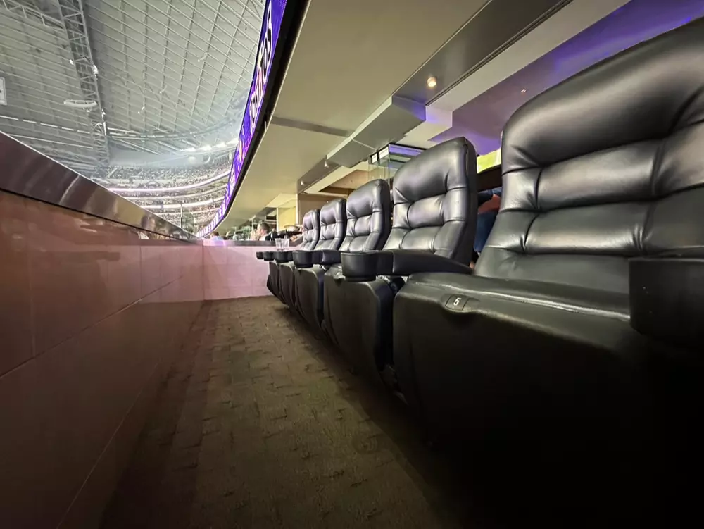 Leather stadium-style seating inside Hall of Fame Suite